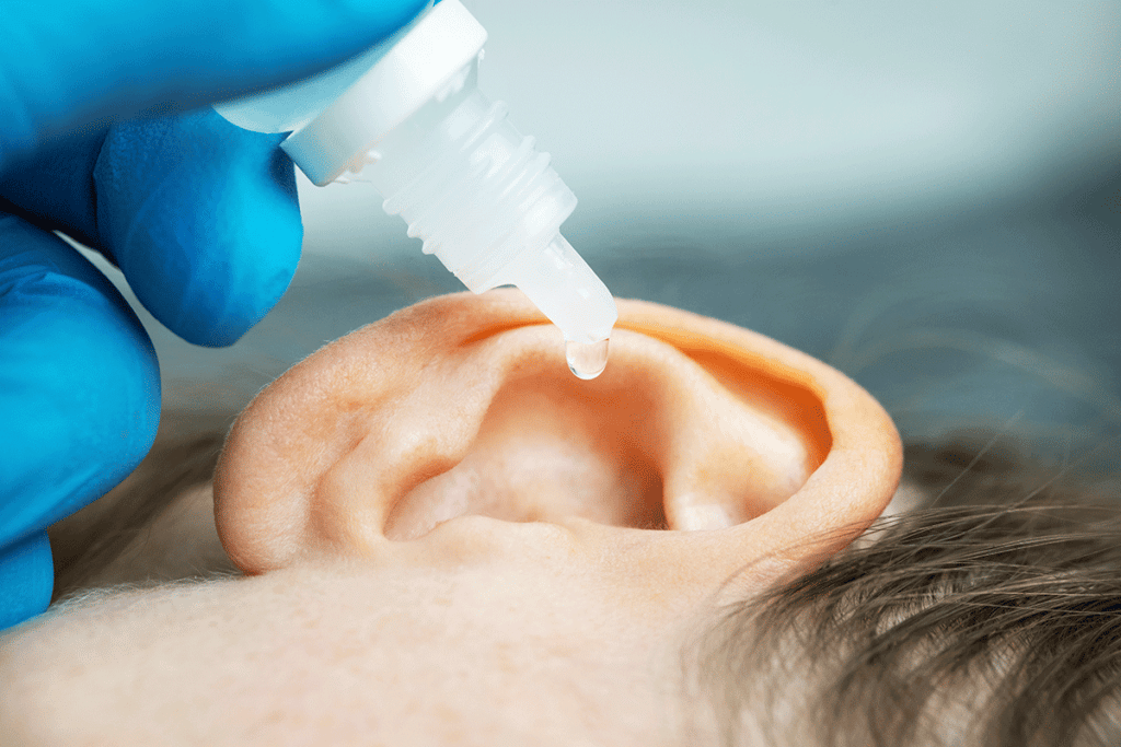 peroxide being put into a child's ear